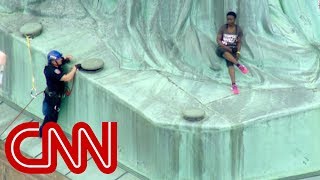 Protester climbs Statue of Liberty [upl. by Kendricks]