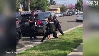 Police officers stop fellow officer punching handcuffed woman during arrest [upl. by Meesaw677]